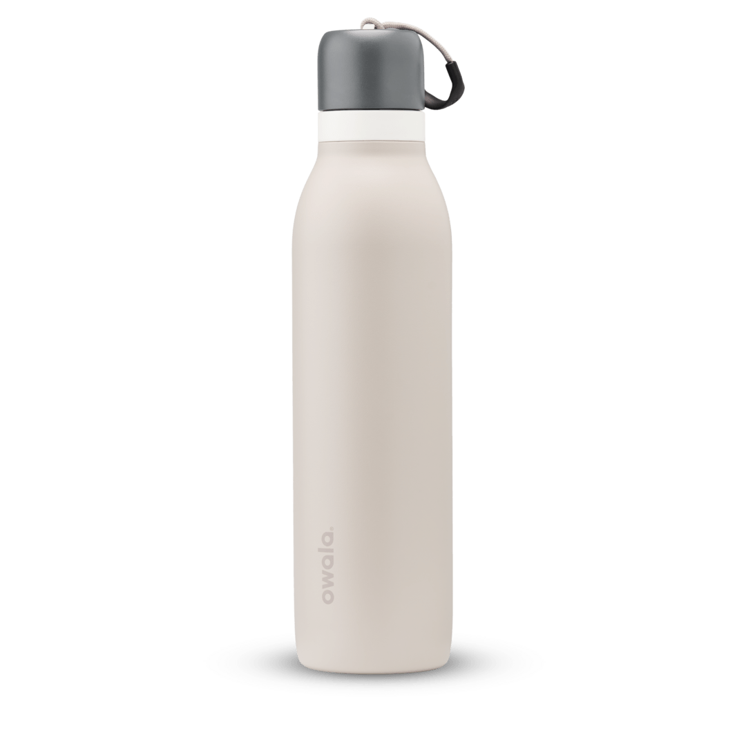 FreeSip Twist 24oz, coral pink body with orange-red lid and purple band; slim insulated bottle